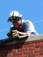 Firefighter atop a roof